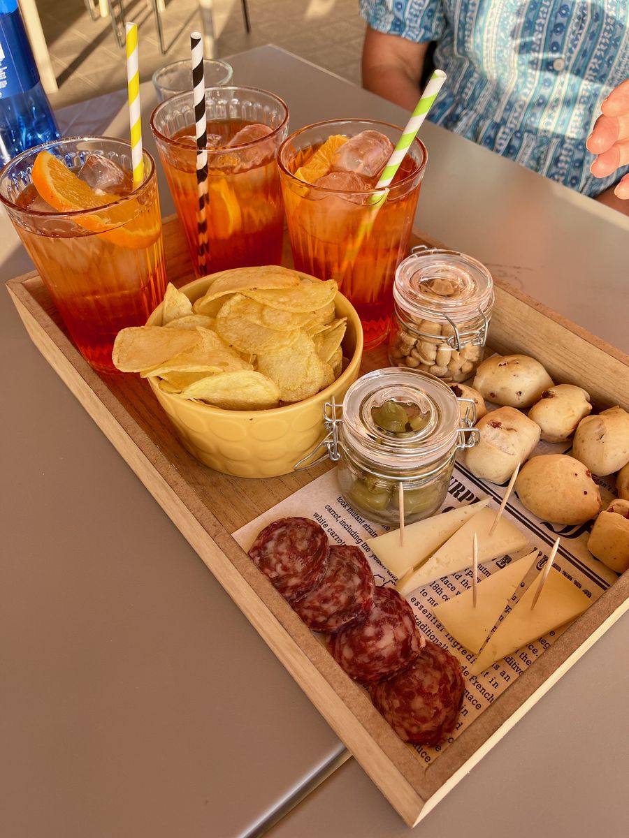 Aperol spritz aperitivo tray with olives, cheese, and salami