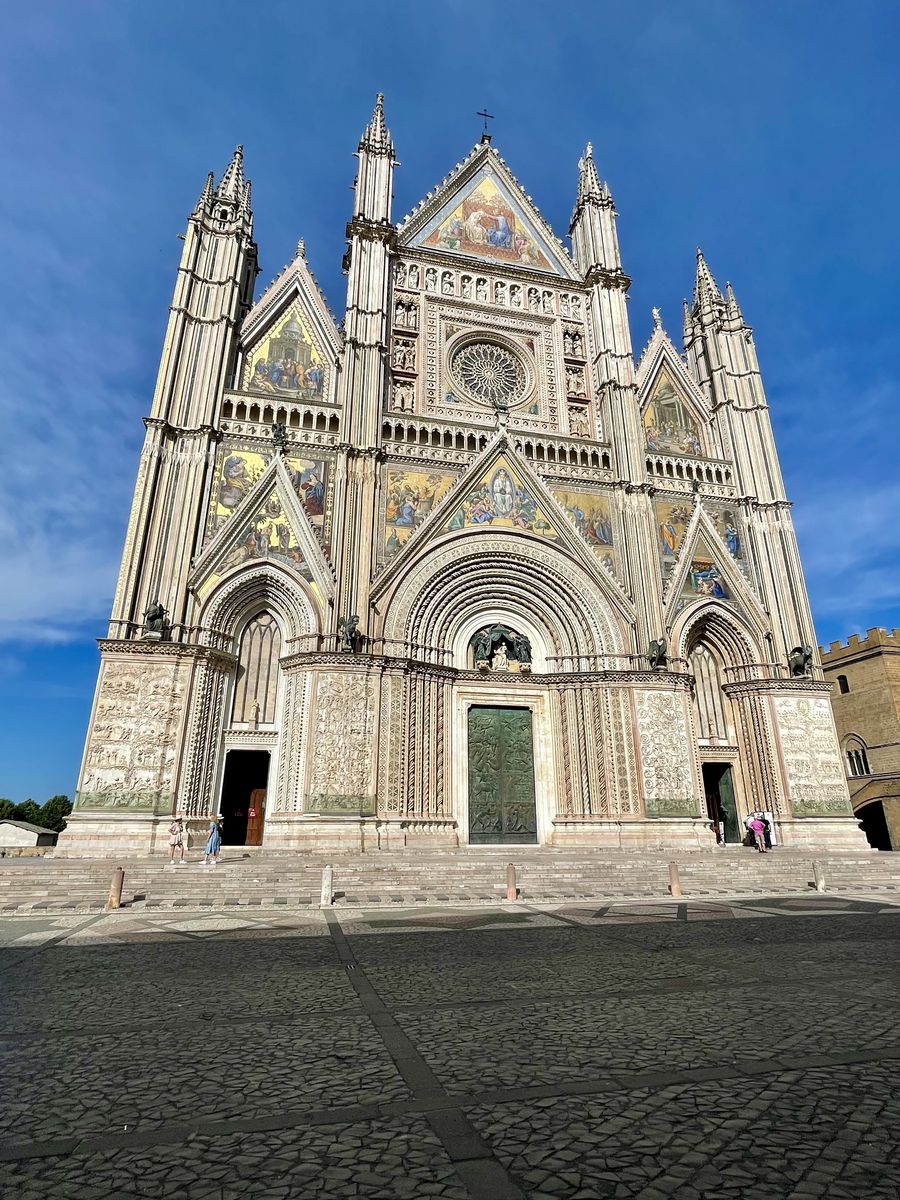 Orvieto Cathedral facade under a blue sky, Italy