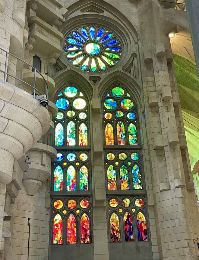 Stained glass windows glowing blue and orange inside the Sagrada Familia, Barcelona